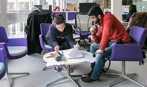 Two students in the Library collaborating
